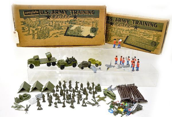 US Army Training Center Playsets: By Marx. Both appear to be the same set in two different boxes. Smaller set appears complete, larger set is missing tin buildings. Original boxes show light wear, larger one has a tear on front. Piece