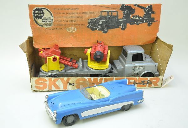 Ideal Plastic Vehicles: 16" long Fix-It Future Car with spare, jack and tools, battery operated lights, one end of front bumper broken; Boxed 4875 Sky Sweeper truck, 24" long, projects images on wall, missing darts. Both cou