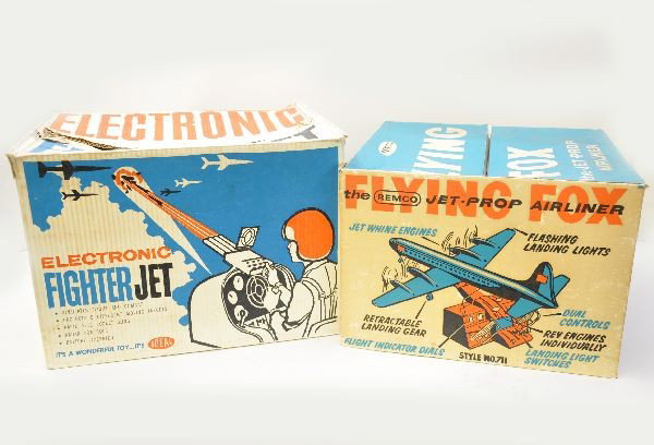 Boxed Remco Airplane Toys: No. 4800 Electronic Fighter Jet, main unit is intact, missing darts, has original instructions, battery operated, has ob with inserts, showing some graffiti; No. 711 Flying Fox Jet-Prop Airliner. This