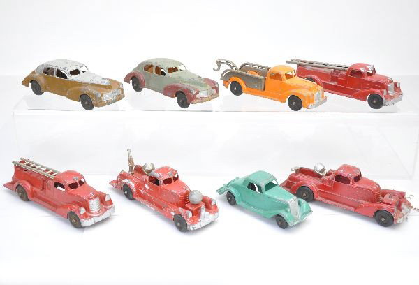 Hubley Vehicle Lot: Two 7" taxi style sedans, wrecker, roadster, 2 fire pumpers, one missing compressor tank, 2 ladder trucks. All show moderate to heavy playwear, C56