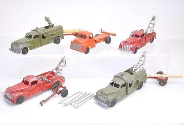 Hubley Vehicle Lot: Two 11' Bell Telephone trucks, both have trailers and replaced tools and logs; 2 different wreckers which show heavy playwear C4-5; log truck, missing load. Otherwise, shows light to moderate playwear