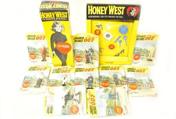 Gilbert James Bond Toy Lot: Super 007 toys include 16114 Honey West figure in box; 16265 Honey West compact set No. 1; 10 3 1/2" assorted figures, all unused or sealed on card, near mint, C9-10