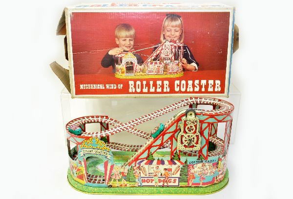 Boxed Chein Roller Coaster: Litho tin, 19" long with 2 original cars, mechanism is functional with bell but drive band has stretched (replacements available). Cars show some wear and surface oxi, nice original box. Otherwise, co
