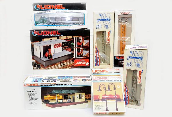 Boxed Lionel Accessories: Two Early 2195 floodlight towers, one ob has torn flap; 12723 microwave tower, 12798 forklift loader station, 2129 illuminated freight station, 2 #2171 goose neck lamps, 12806 lumber truck. All are un