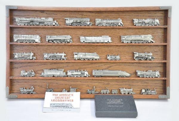 Franklin Mint Greatest Locomotives Display: Nice display containing many pewter scale models of the World's Greatest Locomotives. Visually N-gauge size, complete with all description cards. Includes walnut case with Plexiglas cover. Makes a nic