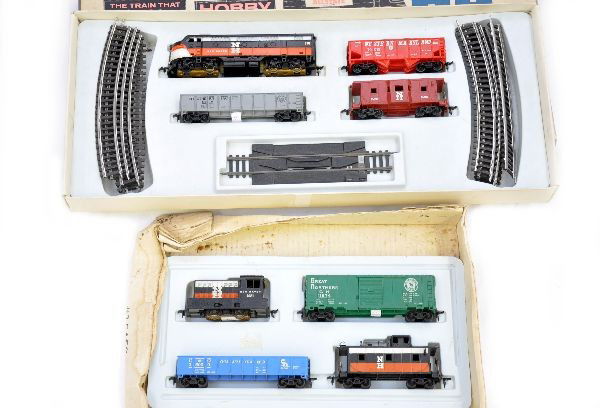 Boxed Marx HO Sets 16460 & 9958: 16460 includes NH switcher and 3 freight cars, insert and rough osb; 9958 includes NH diesel, 3 freight cars, track nice set box with minor tape and insert. Trains show light to moderate playwear, C7