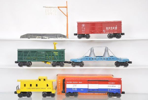 Late Lionel Freight Cars: Scarce 3376 green Bronx Zoo car with tell tale, one incorrect body screw; 6413 Mercury project car, replaced load but scarce teal blue frame; 6428 mail boxcar, unrun with worn ob, (C9); 6014 Bosco box