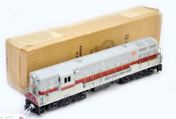 Boxed Lionel 2321 Lackawanna FM: Nice double motor diesel with hairline screw cracks, original decals are 100%, handrails have very light minor oxi spots, battery box is clean, shows light to moderate playwear, crisp ob, re-taped on 