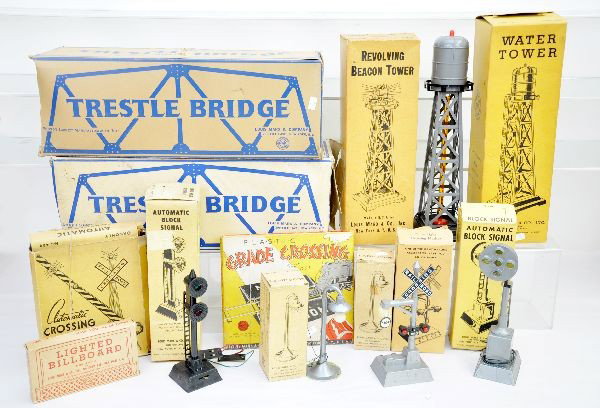 Boxed Marx Accessories: Large assortment including IC & PRR trestle bridges, one with beacon set; 465 water tower; 446 beacon; 066 grade crossing; 1404 block signal; 464 block signal; 1426 banjo; 2 #072 lamp posts; 0226 bill