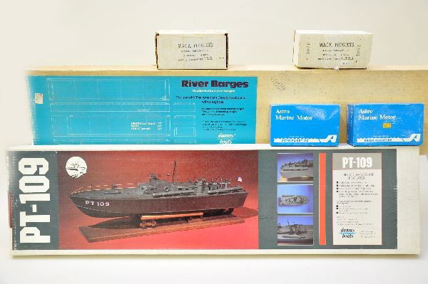 Boxed Wooden Boat Model Kits Plus: Dumas, 1219 River Barges, 43" long; Dumas, 1233 PT 109, mahogany; 1248 Jersey City tug boat kit, no label; 49' Dowzl sport fisherman, no label. Plus, 2 Astro Marine motors and 2 Mack 1200 gear sets. A