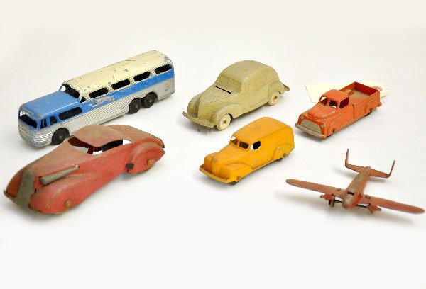 Toy Vehicle Lot: Tootsietoy Greyhound Bus; pick-up, and delivery van; beige sedan penny back, missing closure; Marx airplane (load for toy trains); Marx mid-size sedan (for gas station toy). Otherwise, all show modera