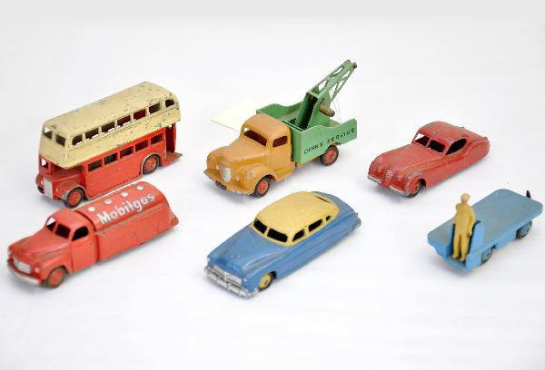 Dinky Vehicle Lot: Hudson sedan, 2 flat tires; 157 Jaguar; 14A B.E.V. truck; Bedford Mobilgas truck; Routemaster bus; Commer wrecker, missing hook and line. All show moderate to heavy playwear, C5-6 but may clean better