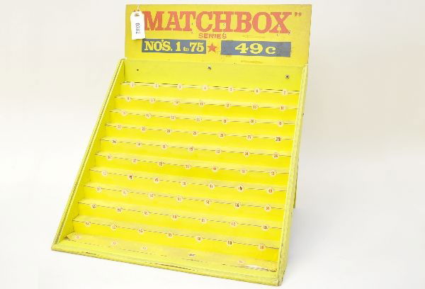 Rare Early Matchbox Store Display: Circa late 1950's, wooden No.1-75 shelf display. 22 1/2" wide, 23" tall, 17" deep. Wood and cardboard construction showing light to moderate wear and a little dusty. Original glass cover (not in photo