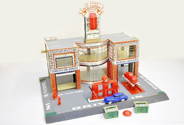 Fantastic Keystone Gas Station: Paper litho on press board, 23" x 17" base, circa 1950's, clean and bright with many accessories, missing metal pole for light and light shade is cracked. Includes 2 vehicles, auto laundry (minus hose