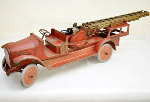 Buddy L Aerial Ladder: Circa 1920's, painted pressed steel, 36" long, ladder mechanism functional, missing extension ladder, a few rust spots here and there. Shows moderate to heavy playwear but still makes a great display 