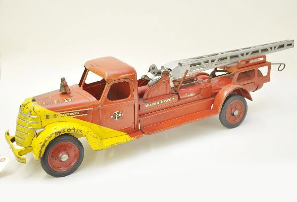 Scarce Large Buddy L Water Tower: Unusual fendered cab, painted pressed steel, 35" long, tank appears intact with no rust, missing connector hose, top nozzle, seat and steering wire. Shows moderate playwear, great display piece. Other