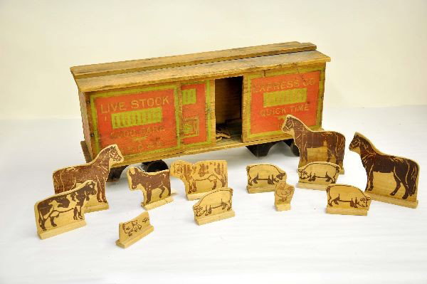 Scarce Converse Stock Car: Early stenciled wood, 20" long, unusual to find with doors and original animals, missing 4 wheels, has wonderful aged patina, graphics read " Express Company Quick Time 1912, MEC&S. Shows moderate pla