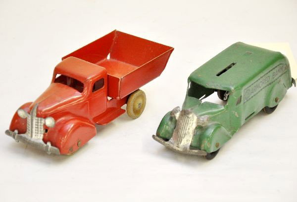 2 Marx 6" Trucks: Dump truck with wooden wheels (one wheel missing), and an armored bank with wooden wheels, missing closure, nice stampings. Both show light playwear, should clean to C7+