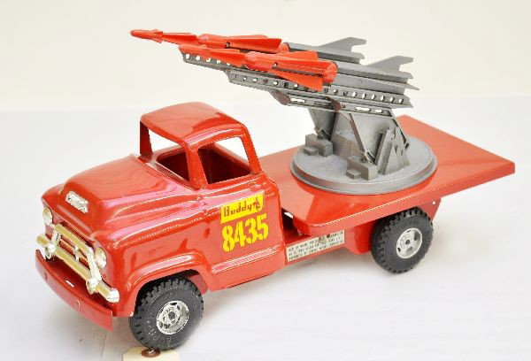 Nice Buddy L Rocket Launcher: Circa 1958, truck numbered 8435, painted pressed steel with plastic wheels and launcher, 15" long, one decal is 97% other is 90%, launcher is missing springs. Truck is clean and shiny showing light pl