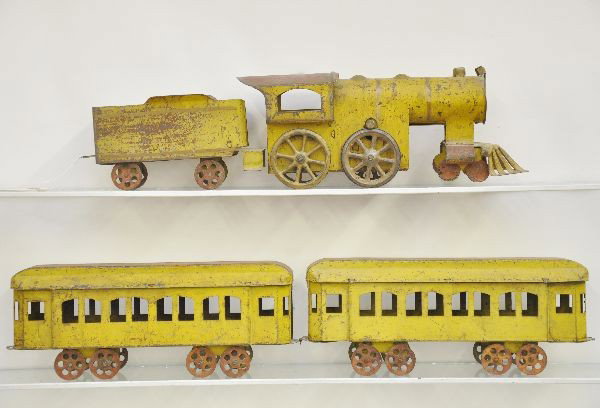Early Scheibel Train Floor Toy: Circa 1890's, hand painted tin with hill climber motor, loco/tender is 18 1/2" long, 42" overall length. Has much better paint than most with nice aged patina and has a great folk art look.