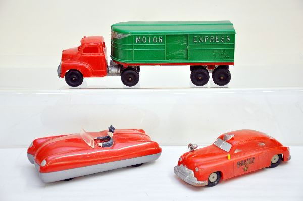 3 Large Plastic Vehicles: 8" future car, missing rubber band for drive; 8" long police car, friction with siren; 12' Hubley motor express truck. All show light to moderate playwear C7-7-