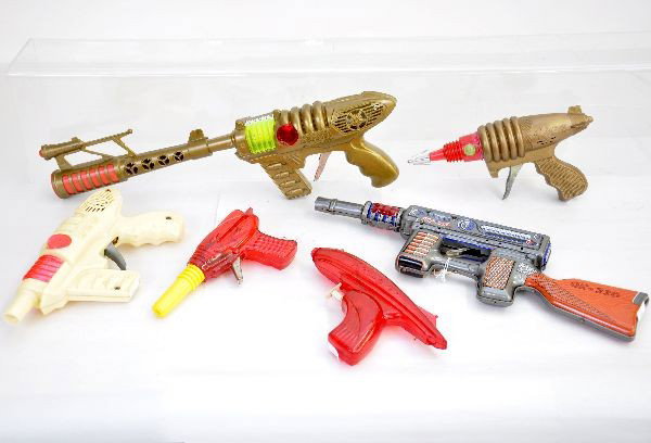 Toy Space Gun Lot: Includes 16" Space Pilot jet ray gun, working with sparks (sight repaired); lunar ray water pistol; red & yellow ray gun; Razor ray gun with sparks; white Space Pilot jet ray gun; tin OK 220 machine g