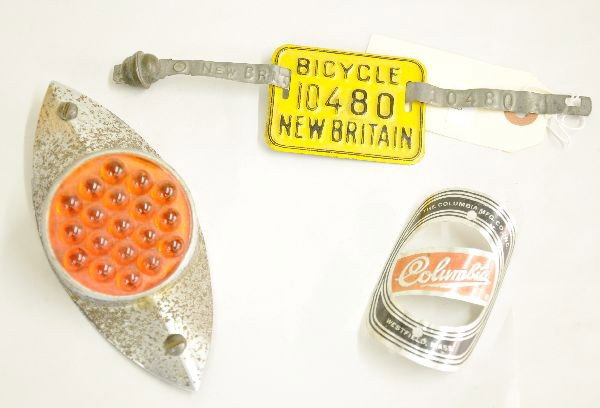 3 Vintage Bicycle Accessories: Early 6" rear fender reflector with some rust; Columbia builder's plate and a rare bicycle license plate from New Britain Connecticut.