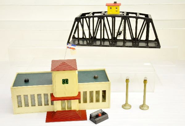 American Flyer Accessories: 499 talking station, clean and complete with replaced flag; 2 #773 lamp posts; nice 750 trestle bridge. All show light to moderate playwear, C7+