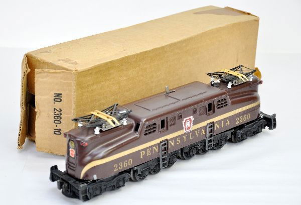 Boxed Lionel 2360 PRR GG1: Tuscan single stripe, even ventilators, one nose decal 95%, others at 100%, clean with nice patina, original box is open both sides. Shows light to moderate playwear, C7