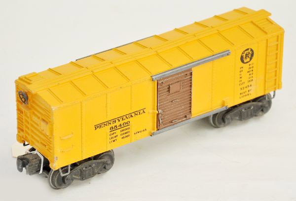 Scarce Lionel 2454 PRR Boxcar: 1946 only, brown door version, clean with strong graphics, FS trucks have been modified with tab couplers. Otherwise, shows light to moderate C7