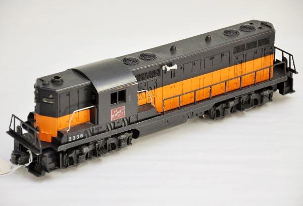 Lionel 2338 Milwaukee Road GP7 Diesel: Orange and black painted on gray mold, a few light box rubs, battery box appears clean, shows light to moderate playwear, C7