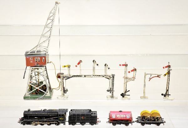 European HO Group: Marklin magnetic gantry crane, some layout scenery disturbance on base; 4 die cast Bing signals; early Hornby 2-8-0 die cast steam loco and tender; Hornby flat with reels and Vacuum Mobilgas tank. All