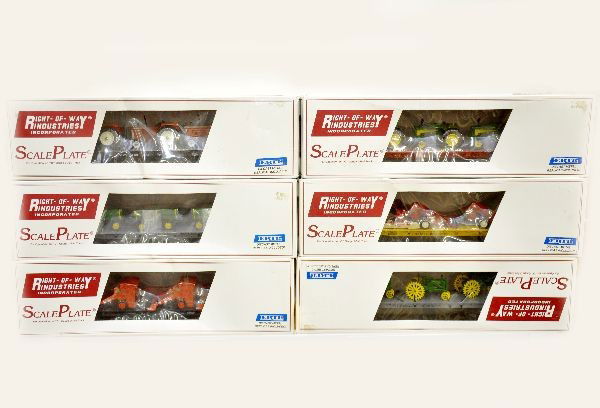 6 Boxed Right-of-Way Flats & Farm Equip.: All have Ertl loads. CB&Q with John Deere tractors, D&H flat with hopper trailers, C&O flat with corn pickers, SF flat with John Deere tractors, B&O flat with AC round balers, NYC flat with Alis Chalm