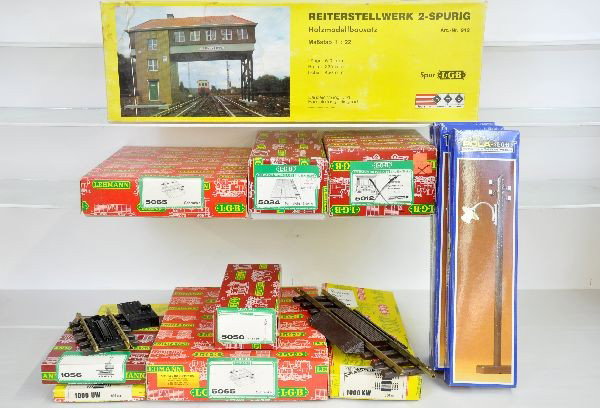Boxed G-Gauge Accessories: 3 Pola 970 electric poles. LGB includes: 912 switch tower, 2 #5065 crossings, 5012 speed control, 1000UW uncoupler, 1000KW direction controllers, 5034 street crossing, 1056 uncoupler, 5050 lamp post. 
