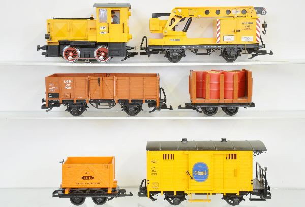 6 Pc. LGB Diesel Freight Set: G Gauge. 2090 Diesel, 1 broken coupler; 4042 crane; 4021 open goods; 4044 Mining car; 4045 Stake flat with drums; 4033 Chiquita Brakeman's van, all show light to moderate playwear, C6-7