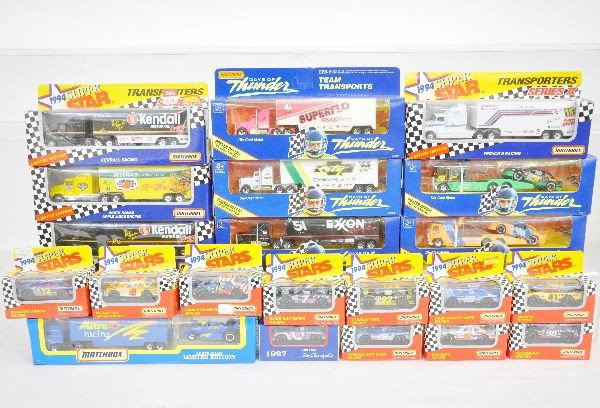 21 Boxed Matchbox Racing Vehicles: Includes 5 Days Of Thunder Transporters; 4-1994 Super Star Transporters with 10-1994 Racing Cars, plus 1997 New Holland Racer, all new in lightly dusty boxes, C9-10