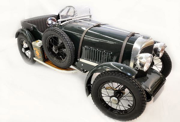 Pressed Steel 1929 Bentley Speed Six Pedal Car: 57" long. Made by Stevenson Brothers for FOA Schwarz. Handmade steel body, operating headlights, aluminum grille, leather seat, boot & hood straps. Pneumatic rubber Schwalbe tires/spoke wheels, and fu