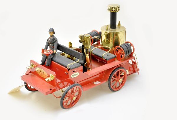 Wilesco Steam Fire Pumper: Germany. This unusual 16" live steam fire pumper makes a great display piece. Missing fender. It shows light signs of handling though, could use a cleaning. C7+-8