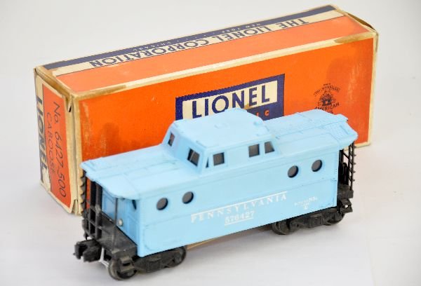 Boxed Lionel Girls 6427-500 Caboose: Lots 127 through 131 make up a complete Lionel Girls set. This lot includes a 6427-500 Girls N5c Caboose, 1 end railing is replaced, the other is repaired, it has a stained original box and shows ligh