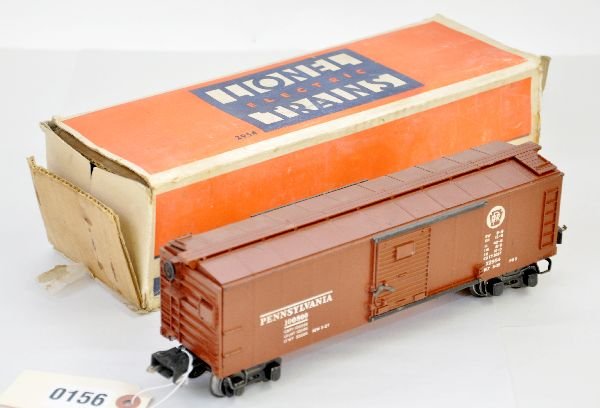 Boxed Lionel 2954 PRR Boxcar: Circa 1940- 1 semi-scale boxcar with high box couplers. Steps are intact, 3 ladder rungs have chips, car is clean & shows moderate playwear with a rough ob with insert, C6+