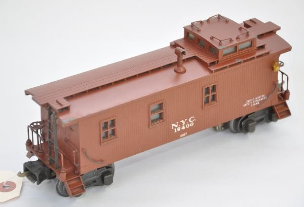 Lionel 2957 NYC Caboose: Circa 1941- 2 semi-scale caboose with low box couplers. The frame and catwalk are unusually straight. Underneath shows a very minor space between body & frame. Car is clean & shows light playwear, oth