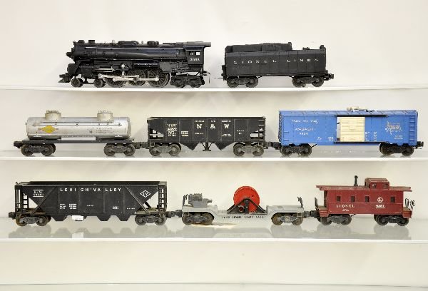 9 Pc Lionel Train Set: 2055 Hudson loco; 6026W tender; 3424 brakeman car only; 3456 N&W Oper. Hopper; 6465 tank car; incomplete 3650 searchlight car; 6436 LV hopper; 6457 caboose; boxed 12885 transformer, like new, otherwis