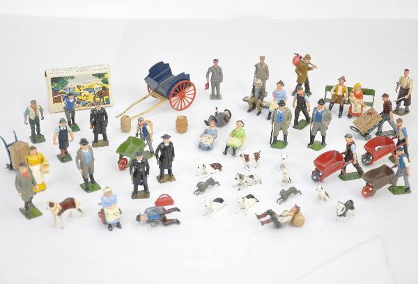 Large Group Of Britains Figures: Over 40 pieces including boxed man with roller, farm wagon, figures, animals with hunt series dogs and others, plus accessories. Grade ranges from C6-C8, so examine photos closely.