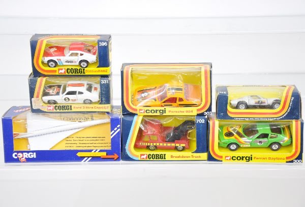 7 Boxed Corgi Vehicles: C650 Concorde; 331 Ford Capri; 319 Lamborghini Muria; 300 Ferrari Daytona; 396 Datzun 240Z; 702 Wrecker; 303 Porsche, all have slightly worn obs, cars are C9
