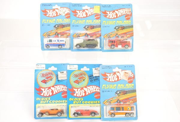 6 Early Carded Hotwheels Vehicles: 1975 1st series black-wall cars include Letter-Getter; Fire-Eater; Gun Bucket & GMC Motor Home, all have nice cards, some with punches; 1977 issues include Auburn & 31 Doozie with creased card, cars a
