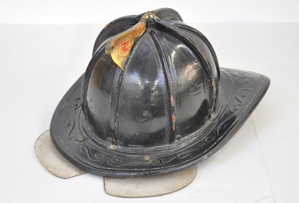 Early Fireman's Hat: Made by Cairns & Brother. Model 518 size 6 1/2 - 7 1/8. Has a tin body with tooled leather rim, brass finial top lettered FD. Over-all shows signs of use and age. Examine photos closely, or call for m