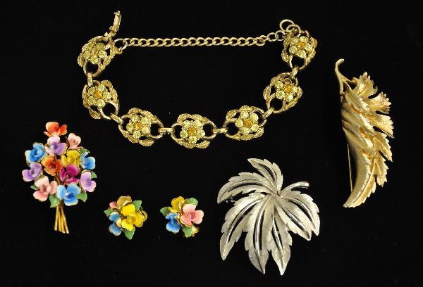 6 Signed Costume Jewelry Pieces: Includes a Coro 2-tone yellow stone bracelet, missing 1 center garnet colored stone; Beautiful enamel flower broach with matching earrings, signed DE Austria; 3" Coro leaf pin & a 2 1/2" silver colore