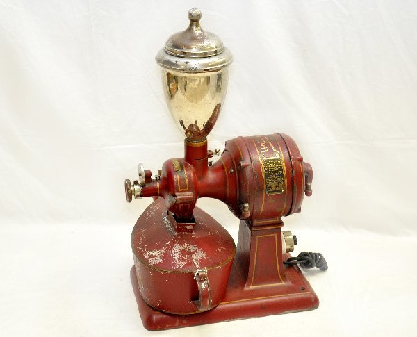 Scarce Early Universal Coffee Grinder: 10 X 17 X 30". This is reputed to be the first electrified coffee grinder. Model 5, pat. date 1911. It is in great shape, but for a little flaking on receptacle. The color and stamping are rich & stro