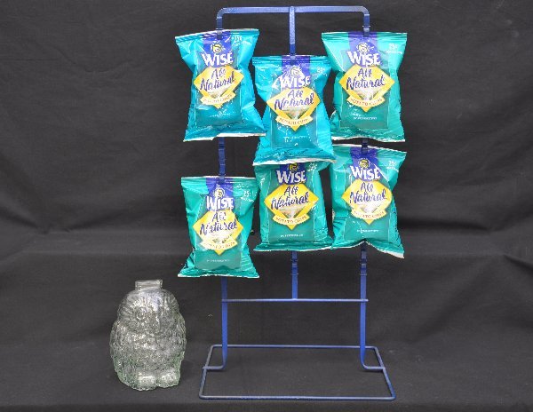 Scarce Wise Potato Chip Bank, Plus: 7" tall. 1950s promotional glass penny bank. Break to open, so few survived. Plus a metal counter rack with modern bags attached.