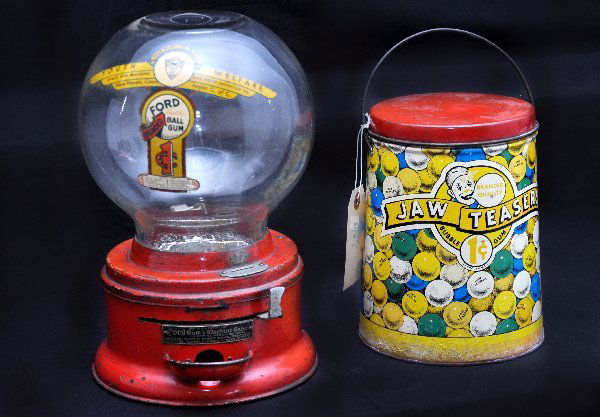 Vintage Ford Gum Ball Machine, Plus: 7 1/2 X 11 1/2" Machine with original globe, decaled, "proceeds donated to Youth Welfare, New Haven, CT", functional with many coins, no key; Plus an original Jaw Teasers Bubble Gum Can, a bit faded.